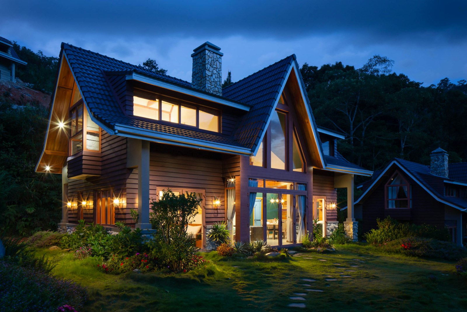 A calm, tree-lined single-family home exterior in warm evening light