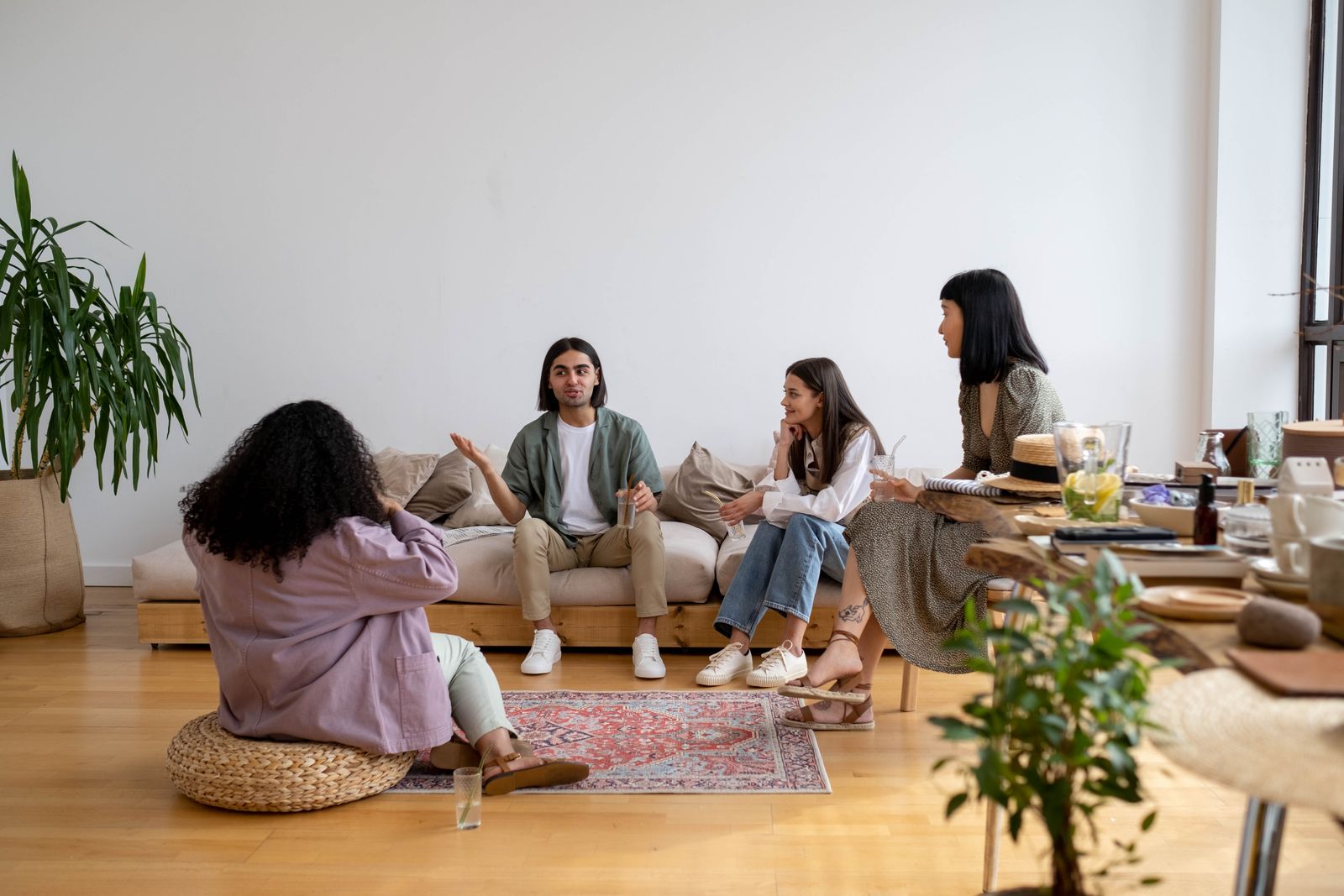 A family in conversation together on a couch in a warm living room